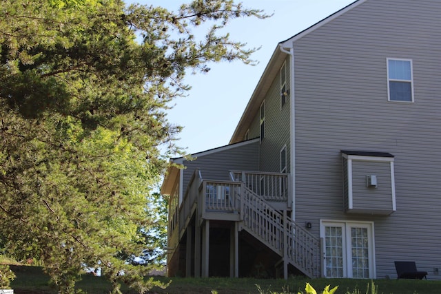 rear view of property with stairway and a wooden deck