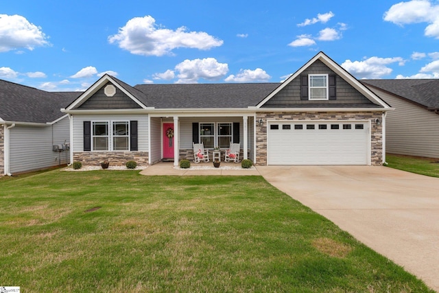 301 Highland Springs Loop, Inman, SC 29349 - view of front of house with stone siding, concrete driveway, covered porch, a front lawn, and a shingled roof