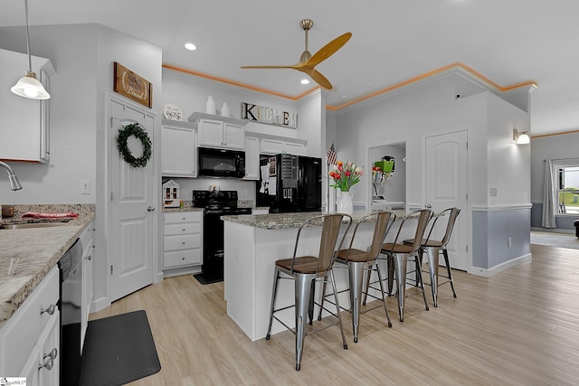 301 Highland Springs Loop, Inman, SC 29349 - kitchen with black appliances, a sink, a ceiling fan, a kitchen island, and a breakfast bar