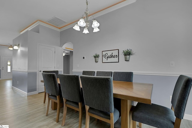 301 Highland Springs Loop, Inman, SC 29349 - dining room featuring arched walkways, crown molding, a chandelier, light wood-style floors, and baseboards