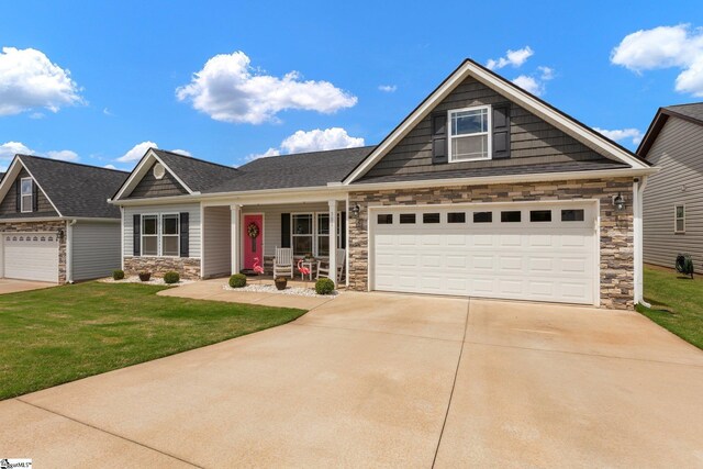 301 Highland Springs Loop, Inman, SC 29349 - craftsman house with stone siding, driveway, a porch, and a front lawn