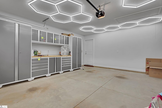 301 Highland Springs Loop, Inman, SC 29349 - garage with a garage door opener and baseboards