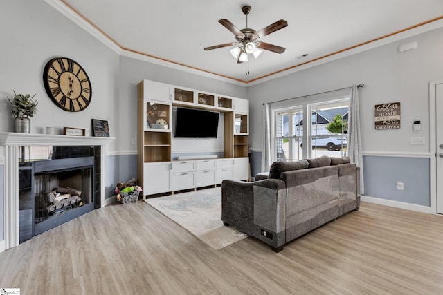 301 Highland Springs Loop, Inman, SC 29349 - living room with wood finished floors, a ceiling fan, a tile fireplace, crown molding, and baseboards