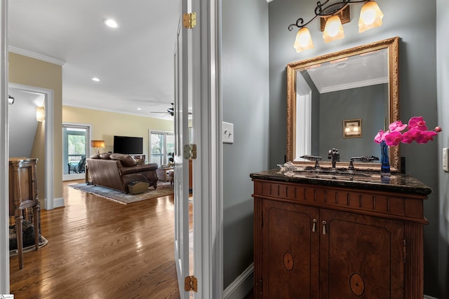 bathroom with ornamental molding, wood finished floors, recessed lighting, vanity, and a ceiling fan