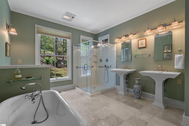 bathroom featuring baseboards, a stall shower, ornamental molding, and a freestanding tub