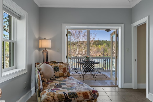 sitting room featuring plenty of natural light, baseboards, and ornamental molding