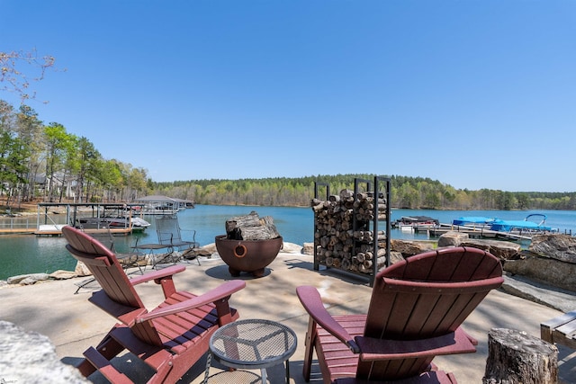 dock area featuring a water view and a wooded view