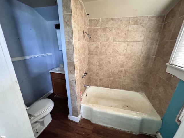 full bath featuring wood finished floors, toilet, shower / washtub combination, and vanity