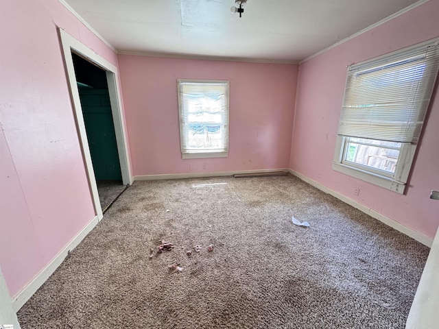 unfurnished bedroom with ornamental molding, carpet, and baseboards