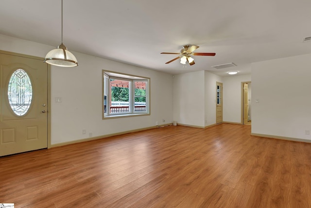 entrance foyer featuring light wood-style flooring, ceiling fan, and baseboards