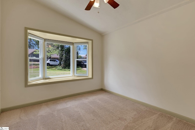 unfurnished room with carpet, lofted ceiling, baseboards, and ceiling fan