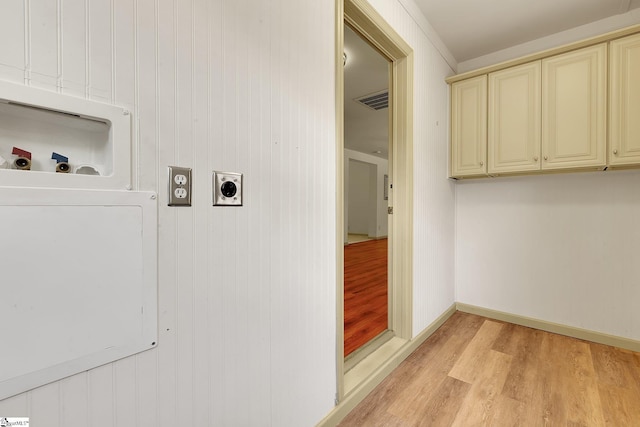 laundry room with hookup for an electric dryer, cabinet space, light wood-style floors, washer hookup, and baseboards