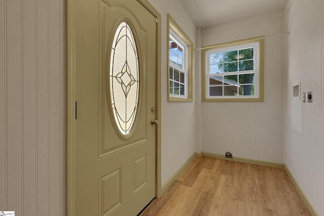 entryway with light wood-style flooring and baseboards