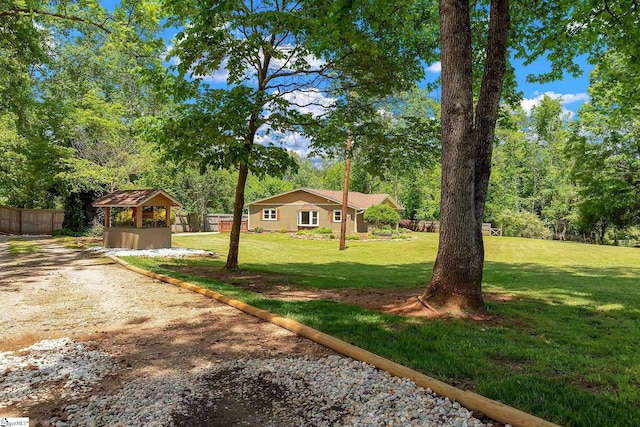 view of yard with a gazebo and view of scattered trees