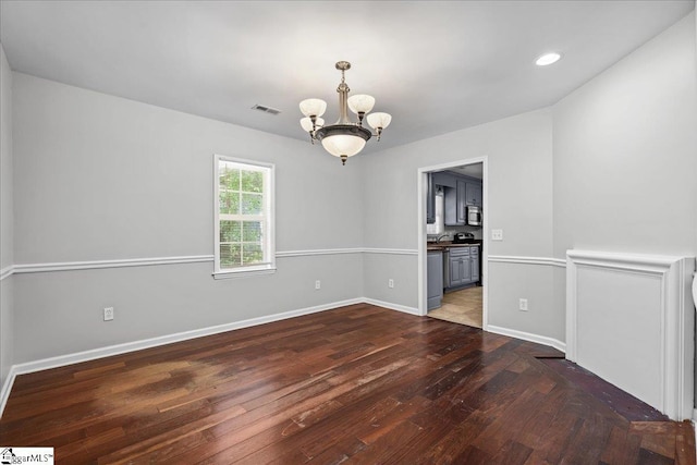 215 Rebecca St, Greenville, SC 29607 - unfurnished room with a chandelier, wood-type flooring, baseboards, recessed lighting, and a sink