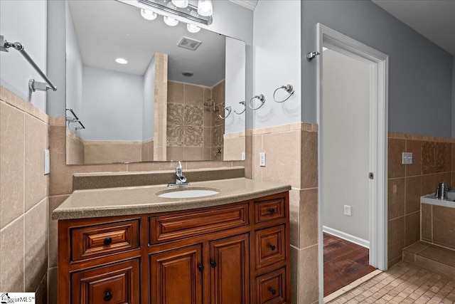 215 Rebecca St, Greenville, SC 29607 - bathroom with tile walls, a wainscoted wall, vanity, and a tile shower