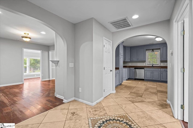 215 Rebecca St, Greenville, SC 29607 - hall with arched walkways, baseboards, a sink, recessed lighting, and light tile patterned floors