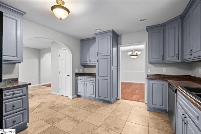 215 Rebecca St, Greenville, SC 29607 - kitchen featuring arched walkways, dark countertops, dishwasher, light tile patterned flooring, and baseboards