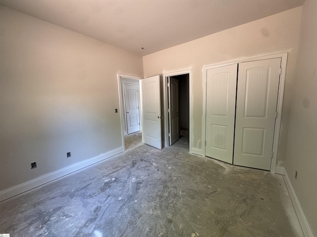 unfurnished bedroom with a closet and baseboards