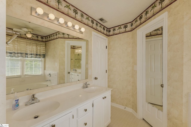 bathroom featuring tile patterned flooring, double vanity, a bath, a ceiling fan, and baseboards