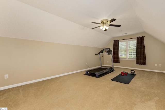 workout area featuring carpet flooring, baseboards, lofted ceiling, and a ceiling fan