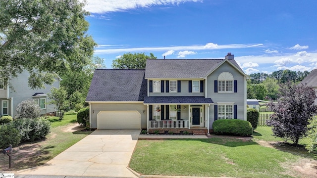 traditional-style house featuring covered porch, driveway, a chimney, a shingled roof, and an attached garage