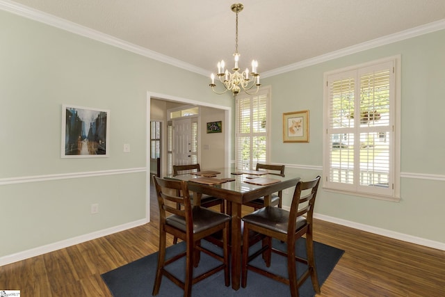 dining area featuring ornamental molding, wood finished floors, a chandelier, and baseboards
