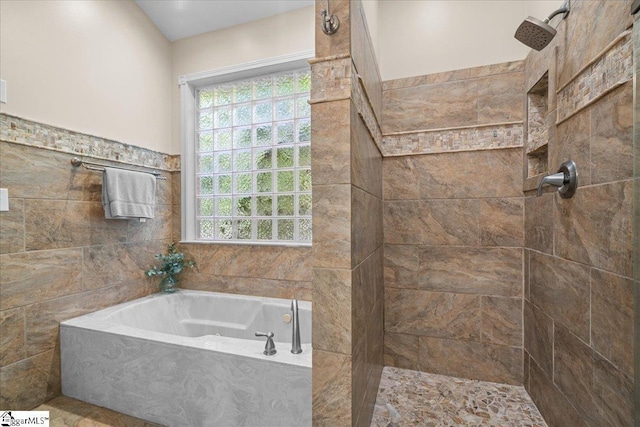 full bathroom with tile walls, tiled shower, and a garden tub