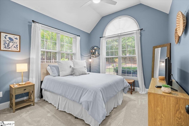 bedroom featuring light colored carpet, vaulted ceiling, baseboards, and ceiling fan