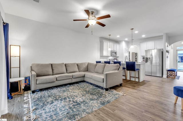 113 Forest Ridge Way, Greenville, SC 29617 - living room featuring arched walkways, a ceiling fan, light wood-style flooring, and recessed lighting