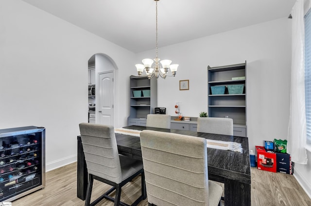 113 Forest Ridge Way, Greenville, SC 29617 - dining room featuring wine cooler, arched walkways, light wood-type flooring, and a chandelier