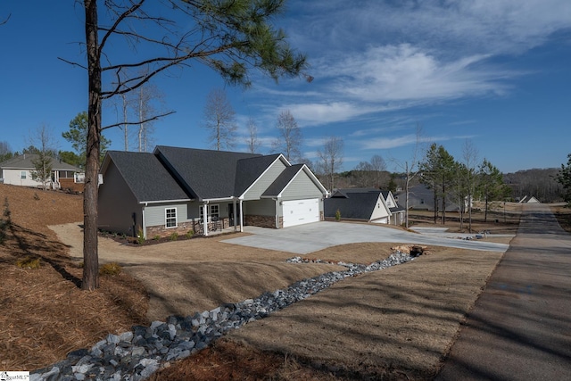 ranch-style house featuring stone siding, driveway, and an attached garage