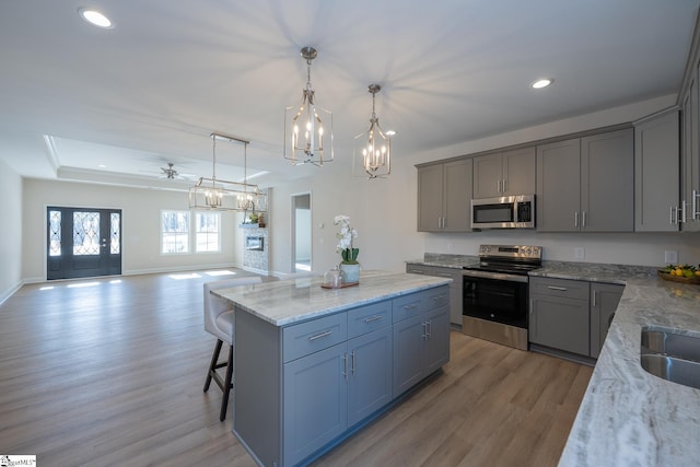 kitchen featuring appliances with stainless steel finishes, gray cabinetry, a chandelier, and recessed lighting