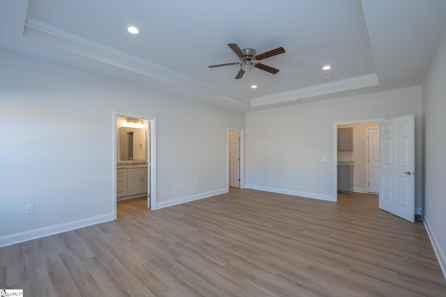 unfurnished bedroom featuring a tray ceiling, ornamental molding, light wood-type flooring, recessed lighting, and baseboards