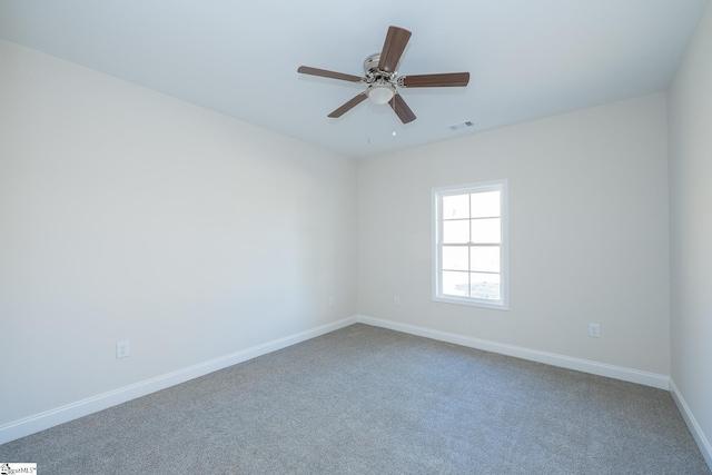 empty room with carpet, baseboards, and ceiling fan