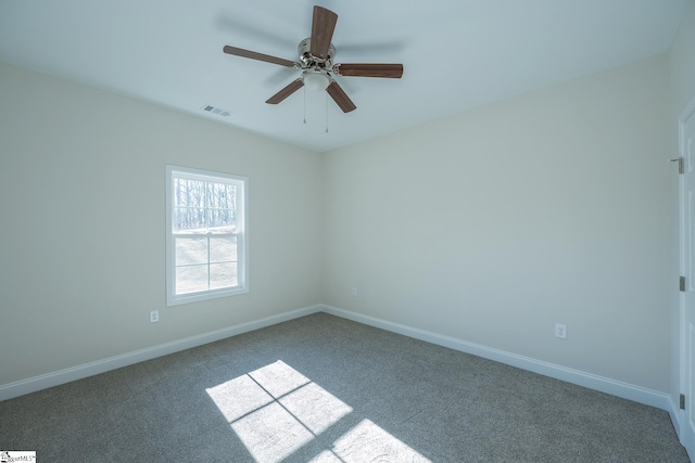 spare room with carpet floors, baseboards, and ceiling fan