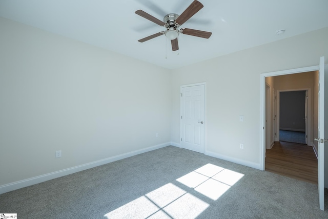 unfurnished bedroom with carpet floors, baseboards, and a ceiling fan
