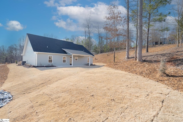 back of property with a shingled roof