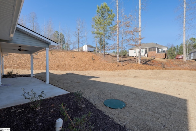 view of yard featuring a ceiling fan and a patio