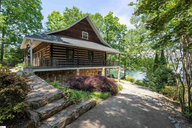 295 Sugarhill Rd, Seneca, SC 29672 - view of front of property featuring log siding, roof with shingles, stone siding, and a water view