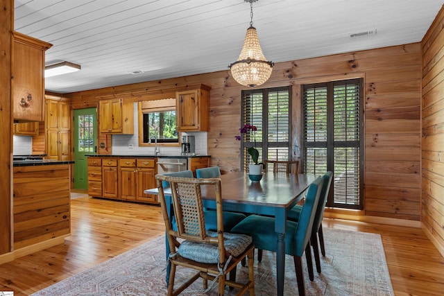295 Sugarhill Rd, Seneca, SC 29672 - dining space with wooden walls, light wood-style floors, and a chandelier