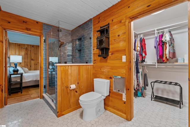295 Sugarhill Rd, Seneca, SC 29672 - full bathroom with wooden walls, a shower stall, toilet, ensuite bath, and a spacious closet