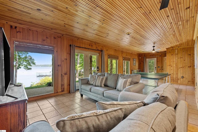 295 Sugarhill Rd, Seneca, SC 29672 - living area featuring a water view, wood walls, plenty of natural light, a ceiling fan, and light tile patterned floors