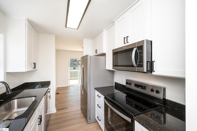 751 Running Creek Ln, Boiling Springs, SC 29316 - kitchen with appliances with stainless steel finishes, a sink, light wood finished floors, white cabinets, and dark stone countertops