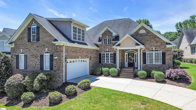 111 Tinsley Ct, Greenville, SC 29615 - view of front of home featuring driveway, an attached garage, brick siding, and roof with shingles
