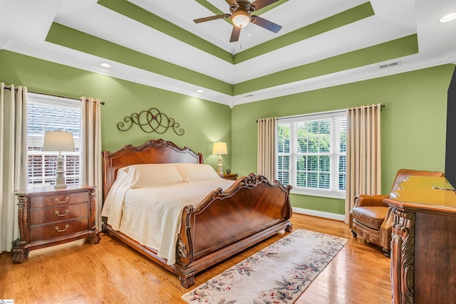 111 Tinsley Ct, Greenville, SC 29615 - bedroom featuring a raised ceiling, multiple windows, light wood finished floors, ornamental molding, and baseboards