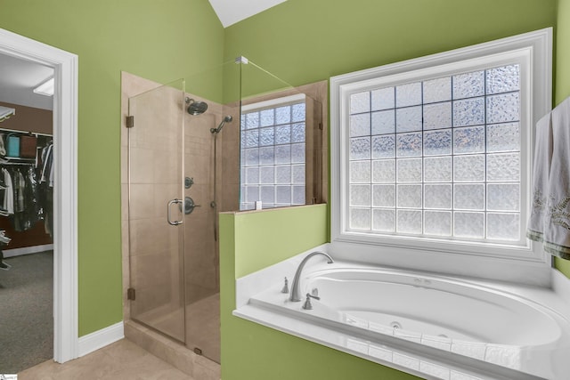 111 Tinsley Ct, Greenville, SC 29615 - bathroom featuring a shower stall, a tub with jets, vaulted ceiling, a walk in closet, and tile patterned flooring