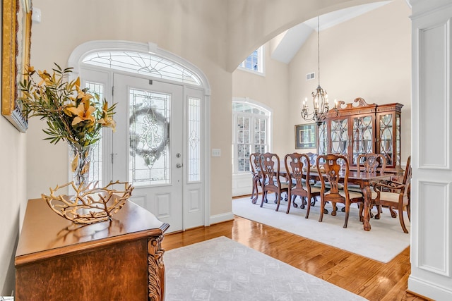 111 Tinsley Ct, Greenville, SC 29615 - entryway featuring wood finished floors, arched walkways, a chandelier, and a towering ceiling