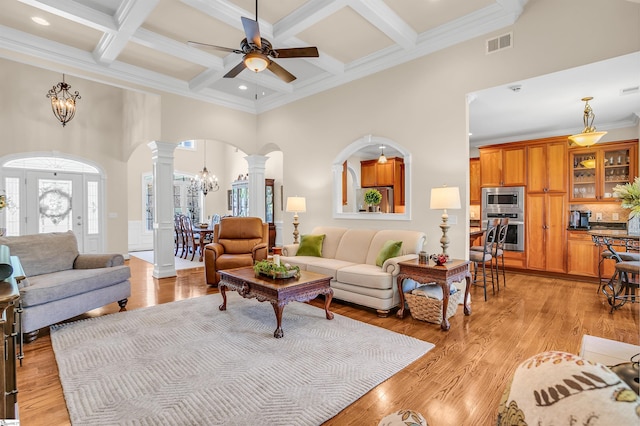 111 Tinsley Ct, Greenville, SC 29615 - living room featuring decorative columns, arched walkways, a high ceiling, a chandelier, and ceiling fan