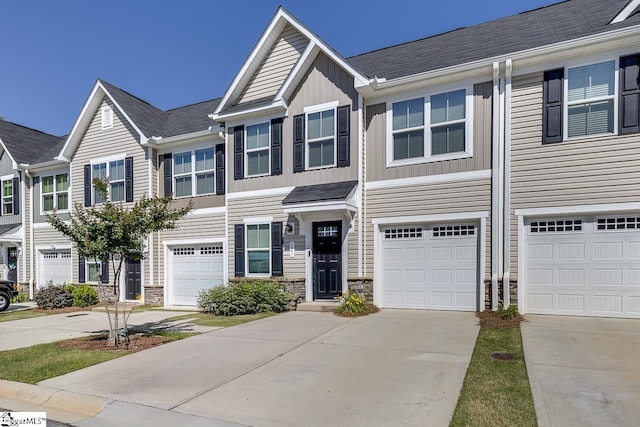 321 Aldworth Ln, Fountain Inn, SC 29644 - view of property featuring stone siding, driveway, a garage, and board and batten siding